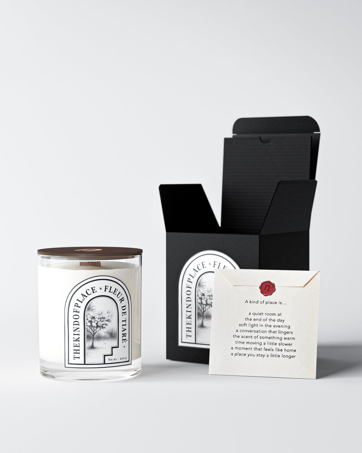 Fleur de Tiaré candle in opened kraft packaging with tissue paper and a printed place card.